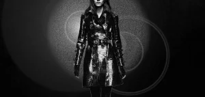 black and white photo of model in black burberry crocodile trenc hcoat